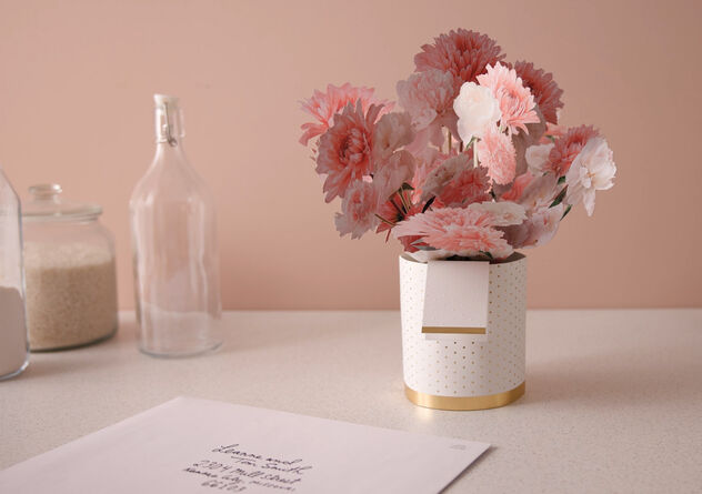 Paper flowers and vase on a kitchen counter