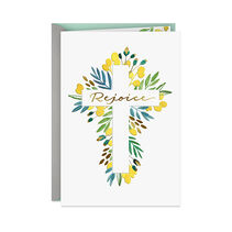 Gold script reading ‘Rejoice’ in a cross-shaped relief made by flowers.