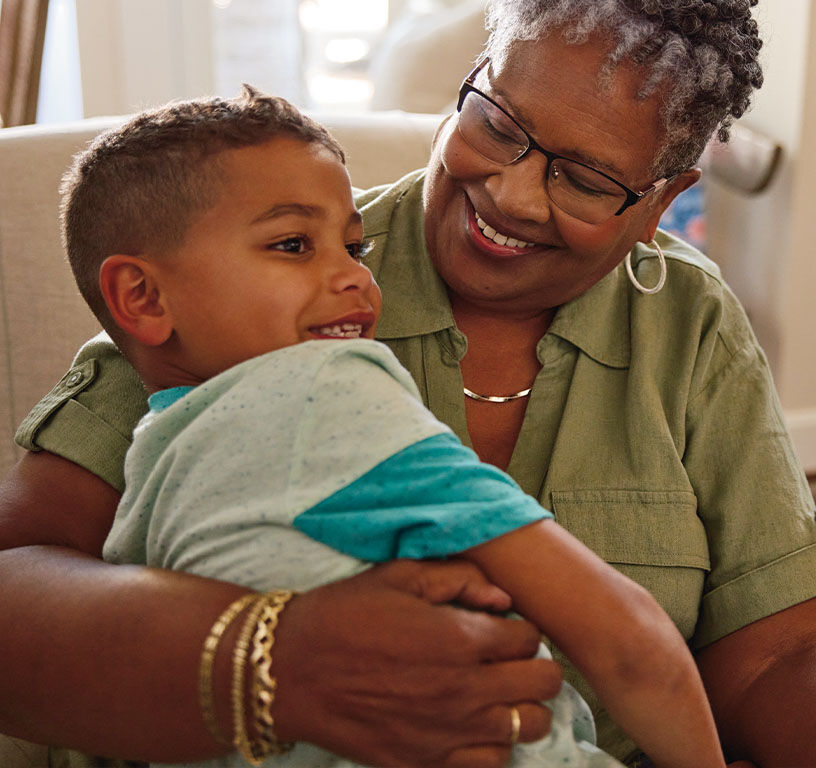 Woman smiling and hugging a child