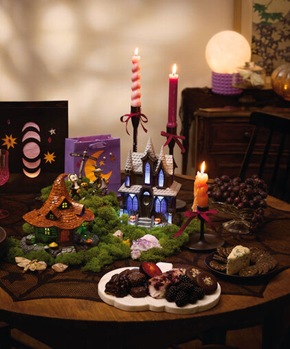 A snack table spread decorated with witch-themed accents.
