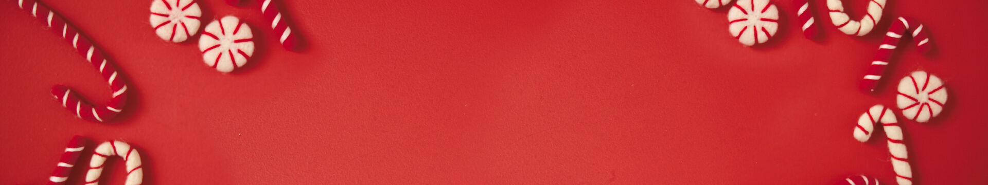 red background with candy canes and peppermints